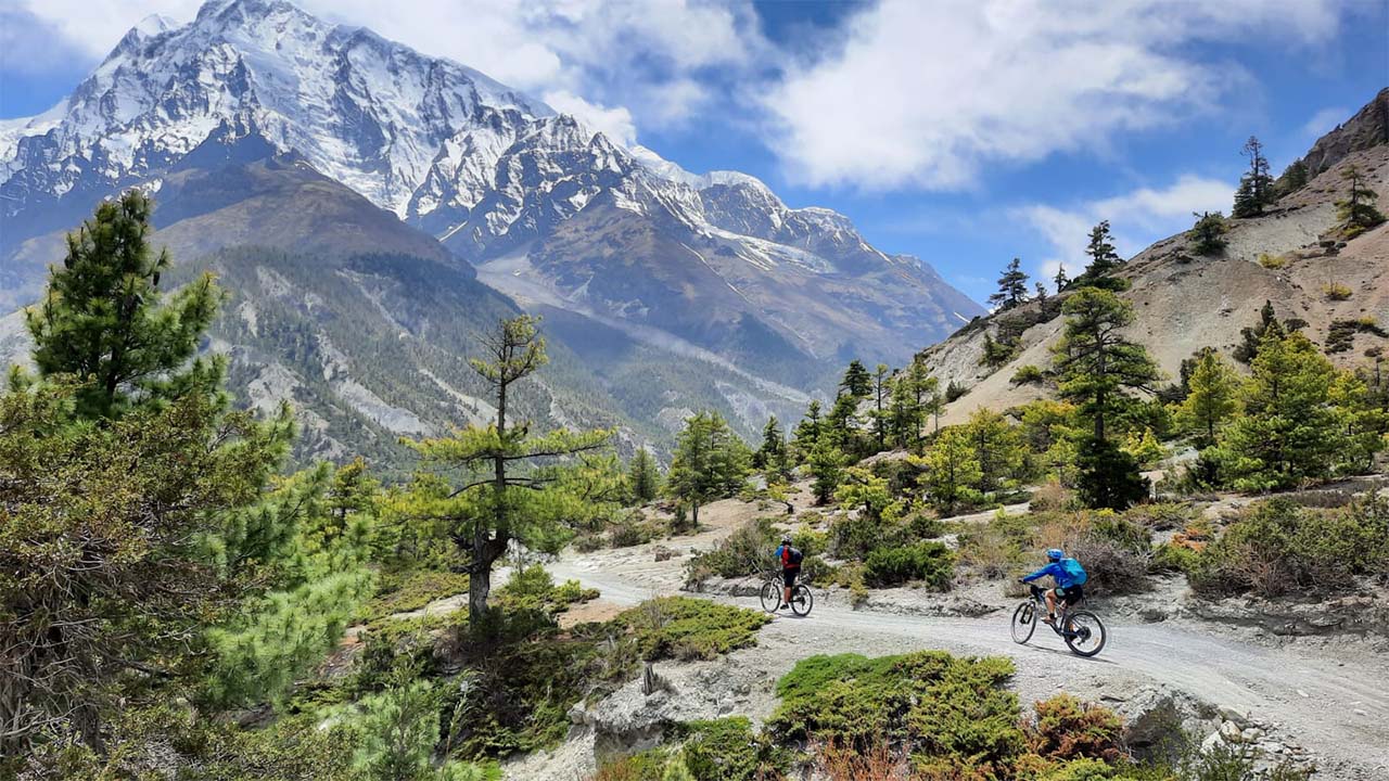 Two mountain bikers are heading towards Manang during their MTB tour to Annapurna Circuit.
