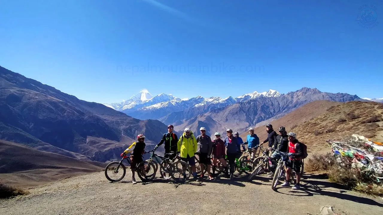 Mountain bikers are ready to take the picture with the backdrop of Dhaulagiri during the Mustang mountain bike tour in Nepal.